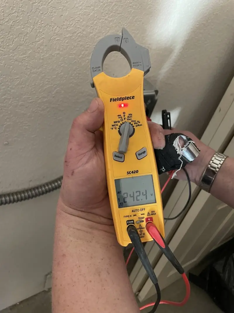 Voltage testing with clamp meter during Outlet Installation in Tucson Estates